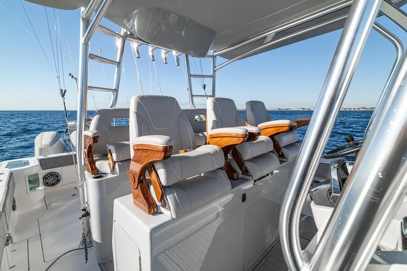 Slide: The Image of Luxurious seating on 2026 SeaVee 420Z boat with ocean backdrop and fishing rods. - 67