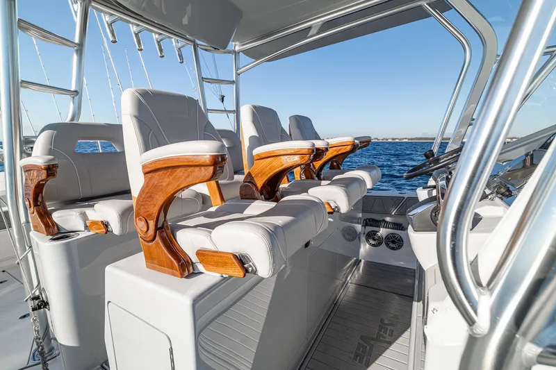Slide: The Image of 2026 SeaVee 420Z boat interior with luxurious seating and wooden accents on open water. - 70