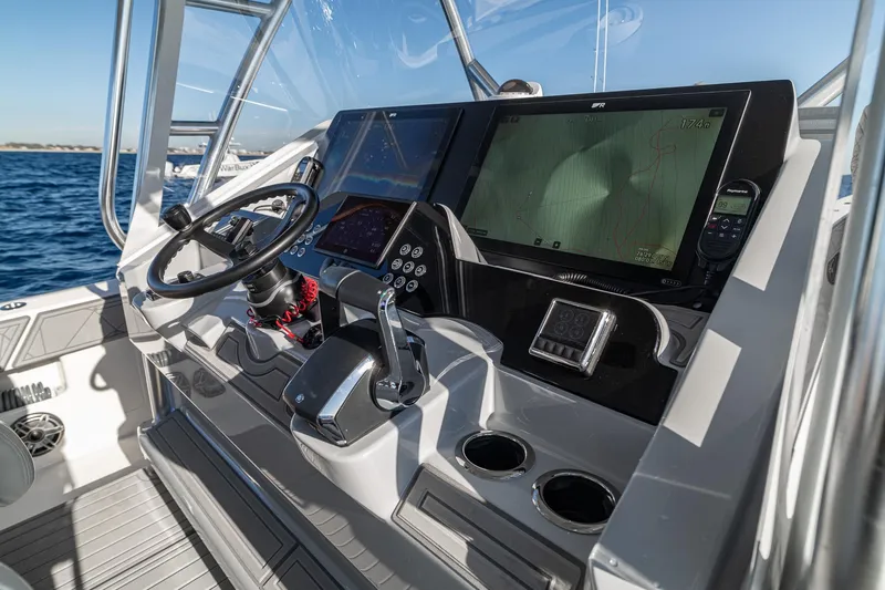 Slide: The Image of Helm of 2026 SeaVee 420Z boat with advanced navigation displays and controls. - 76