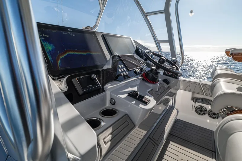 Slide: The Image of 2026 SeaVee 420Z boat console with speakers and display screen, under bright sunlight. - 77
