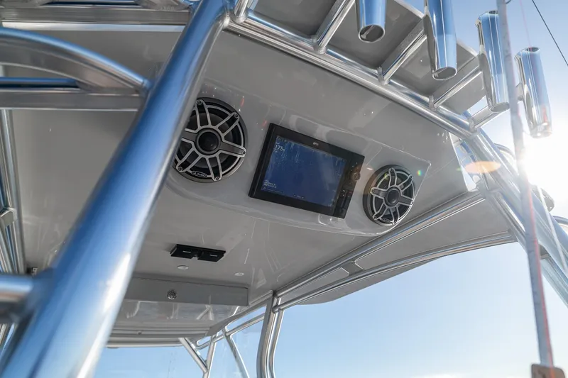 Slide: The Image of 2026 SeaVee 420Z boat console with speakers and navigation screen under sunny sky. - 78