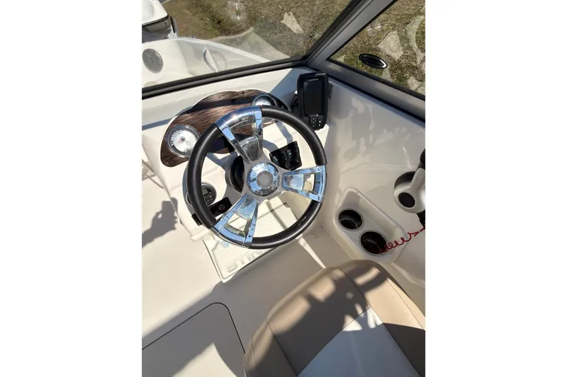 Slide: The Image of 2018 Stingray 191 DC boat dashboard with steering wheel and controls. - 11