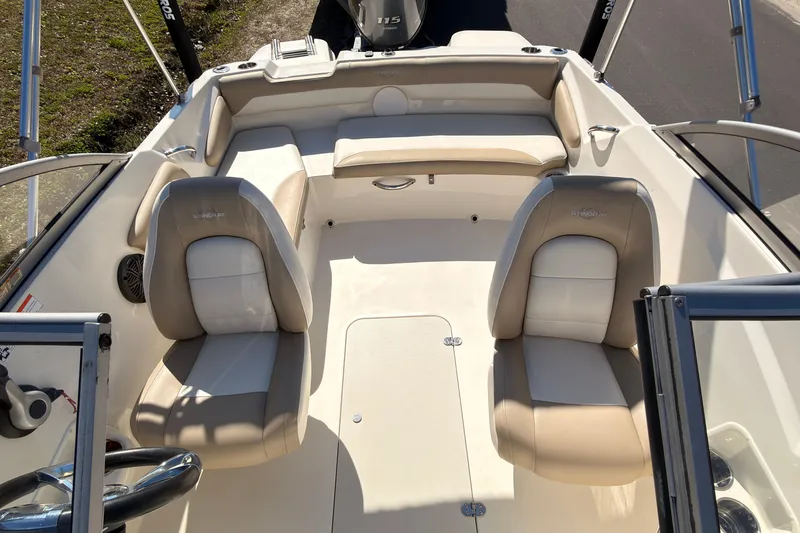 Slide: The Image of 2018 Stingray 191 DC boat interior with beige and white seating arrangement. - 6
