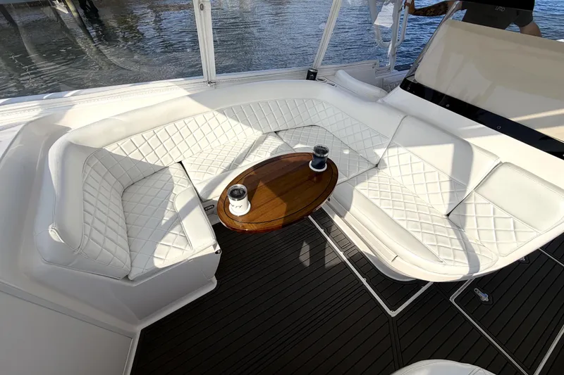 Slide: The Image of 2014 Intrepid 400 Cuddy boat interior with fishing rod holders and custom "Big T's" cooler. - 10