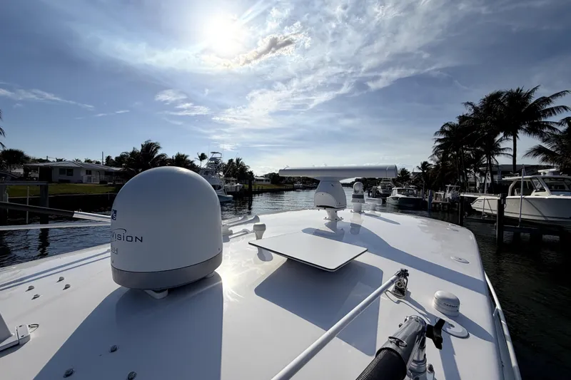 Slide: The Image of 2014 Intrepid 400 Cuddy boat with elegant deck and scenic waterfront view. - 14