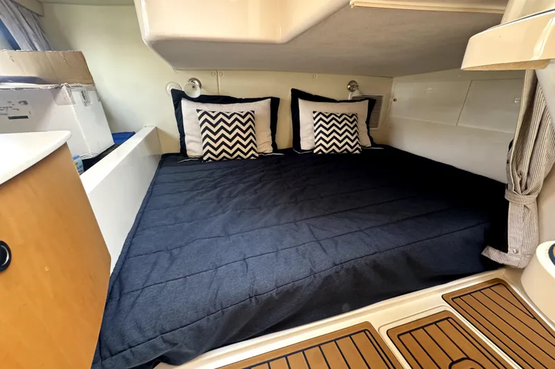 Slide: The Image of 2014 Intrepid 400 Cuddy cabin with cozy bed and chevron pillows. - 22