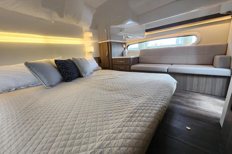 Slide: The Image of Luxurious interior of 2020 Regal 38 XO yacht with cozy bed and seating area. - 10