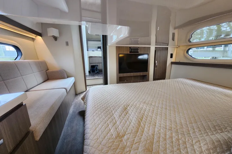 Slide: The Image of Luxurious interior of 2020 Regal 38 XO yacht with cozy bed and seating area. - 11