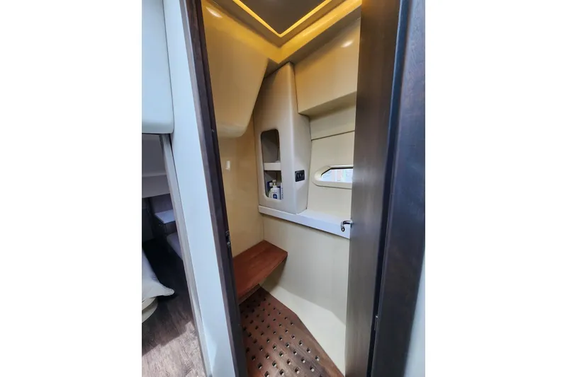 Slide: The Image of Interior of 2020 Regal 38 XO yacht, featuring a compact, modern bathroom space. - 13
