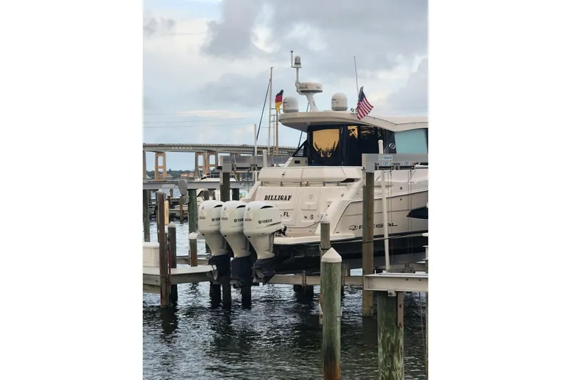 Slide: The Image of 2020 Regal 38 XO yacht docked with triple Yamaha outboard engines. - 2