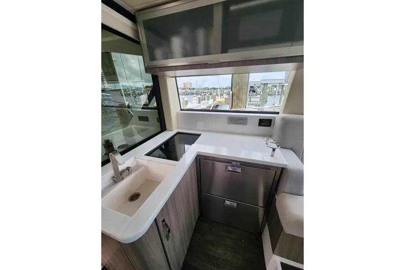 Slide: The Image of Modern kitchen area in 2020 Regal 38 XO yacht with sleek design and waterfront view. - 6
