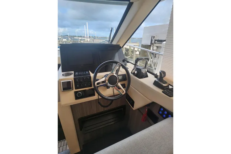 Slide: The Image of 2020 Regal 38 XO yacht helm with steering wheel and control panel. - 7
