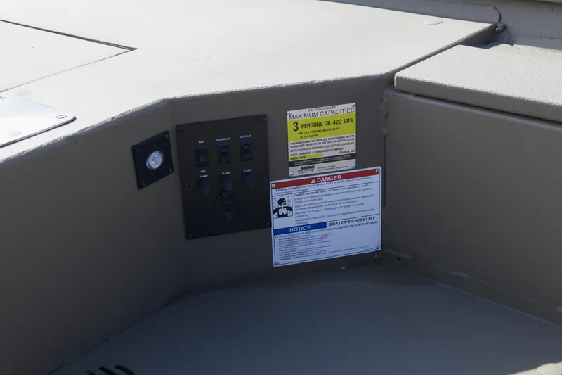 Slide: The Image of Control panel and safety labels on 2026 G3 Gator Tough 16 DK boat interior. - 6