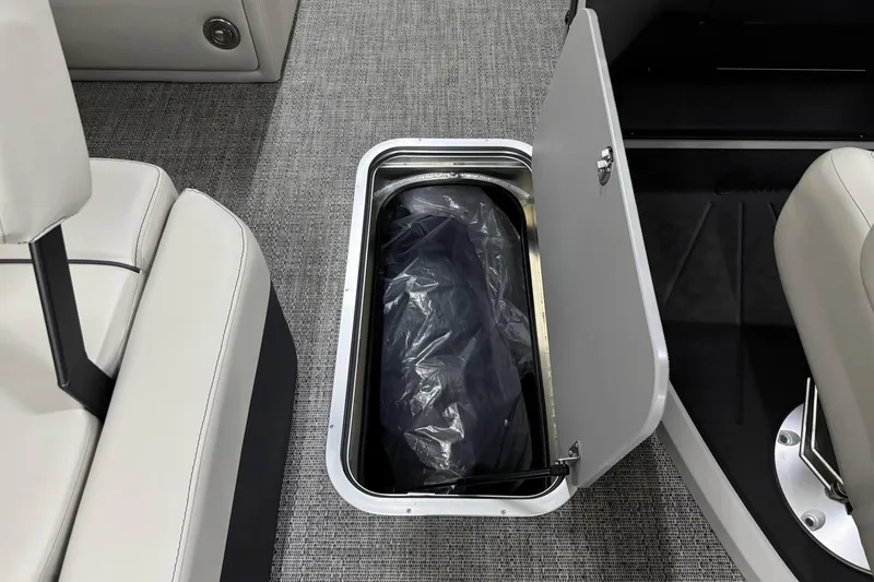 Slide: The Image of 2026 Barletta Cabrio 24M boat interior storage compartment with open hatch and seating. - 31