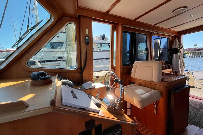 Slide: The Image of 2006 Sabre 36 Flybridge Sedan docked in a marina, clear blue sky. - 1