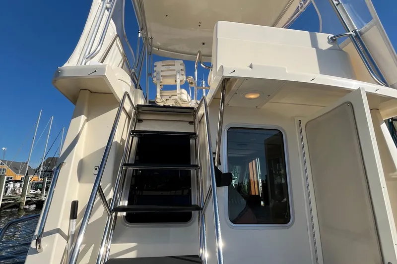 Slide: The Image of 2006 Sabreline 36 Fly cruising on a scenic waterway under a clear blue sky. - 10