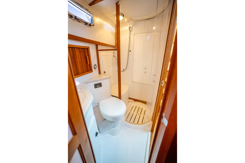 Slide: The Image of Bathroom interior of 2006 Sabreline 36 Fly yacht, featuring shower and toilet. - 101