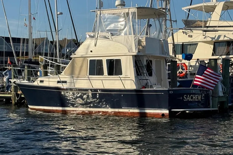 Slide: The Image of 2006 Sabreline 36 Fly yacht docked in a marina under clear blue skies. - 47