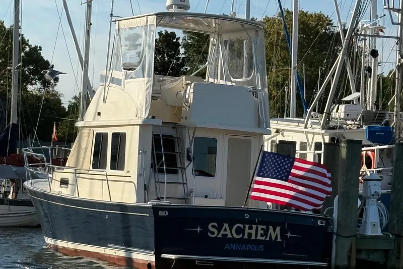 Slide: The Image of 2006 Sabreline 36 Fly yacht on calm water, clear sky background. - 48