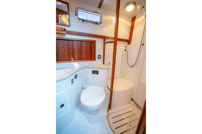 Slide: The Image of Bathroom interior of 2006 Sabreline 36 Fly yacht, featuring shower and toilet. - 100
