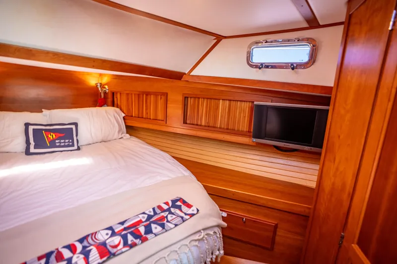 Slide: The Image of Cozy cabin interior of 2006 Sabreline 36 Fly with bed, TV, and wooden accents. - 103