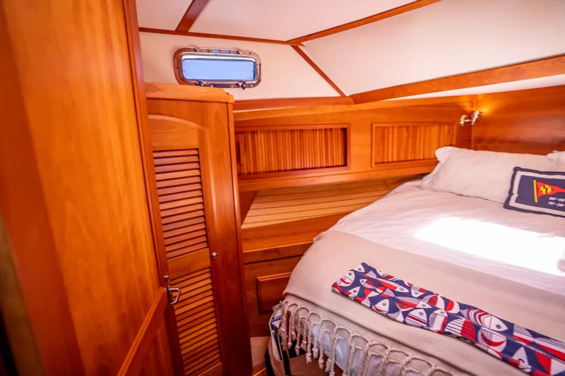 Slide: The Image of Luxurious 2006 Sabreline 36 Fly cabin interior with wooden finishes and cozy bedding. - 104