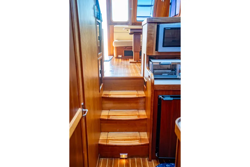 Slide: The Image of Interior of 2006 Sabreline 36 Fly yacht with wooden stairs and modern kitchen appliances. - 106