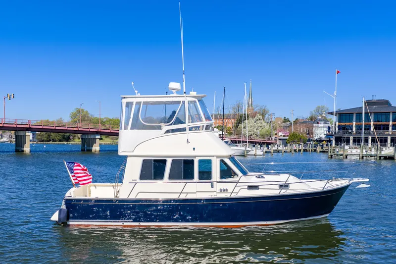 Slide: The Image of 2006 Sabreline 36 Fly yacht on water near a bridge and marina. - 109