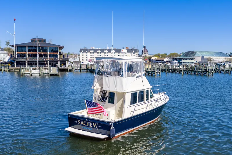 Slide: The Image of 2006 Sabreline 36 Fly yacht docked in a marina with American flag. - 113