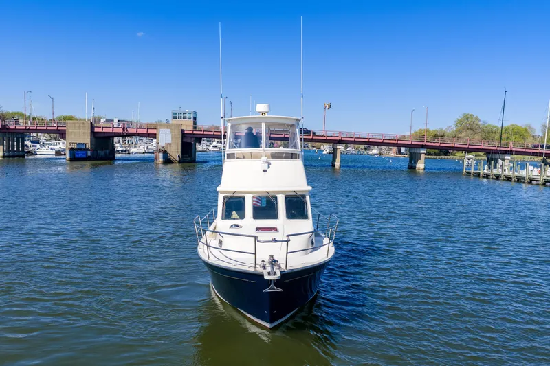 Slide: The Image of 2006 Sabreline 36 Fly yacht on water near a bridge under clear blue sky. - 116