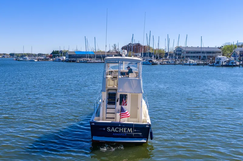 Slide: The Image of 2006 Sabreline 36 Fly yacht cruising in Annapolis harbor with marina backdrop. - 120