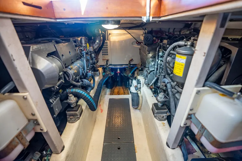 Slide: The Image of Engine room of a 2006 Sabreline 36 Fly, showcasing dual engines and mechanical components. - 124