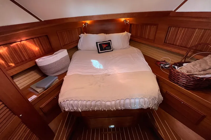 Slide: The Image of Cozy cabin interior of 2006 Sabre 36 Flybridge Sedan with wooden accents and comfortable bedding. - 2
