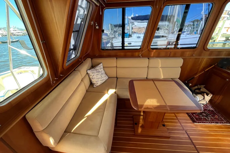 Slide: The Image of Interior of 2006 Sabre 36 Flybridge Sedan with beige seating and wooden table. - 20