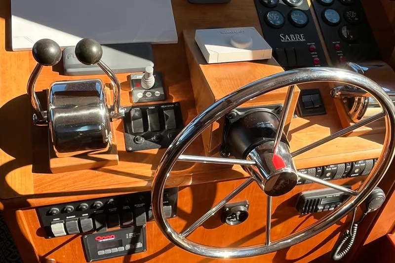 Slide: The Image of Helm of 2006 Sabre 36 Flybridge Sedan with steering wheel and control panel. - 25