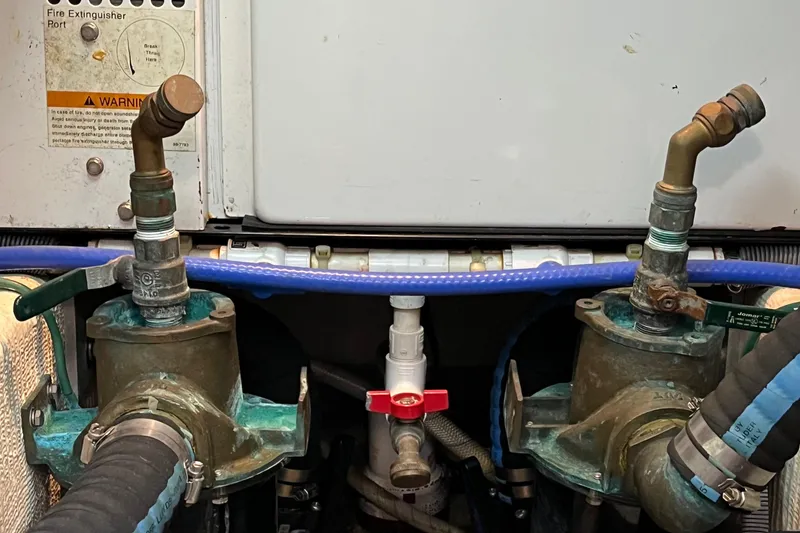 Slide: The Image of Engine room of 2006 Sabre 36 Flybridge Sedan with fire extinguisher port and plumbing components. - 44