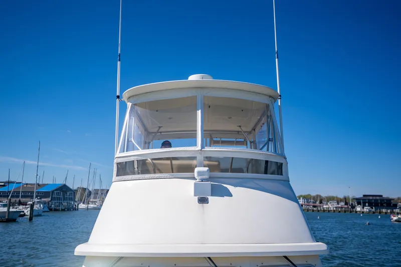 Slide: The Image of 2006 Sabreline 36 Fly yacht docked in a marina under clear blue skies. - 49