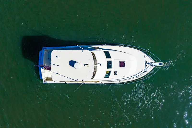 Slide: The Image of Aerial view of 2006 Sabreline 36 Fly yacht on green water. - 50