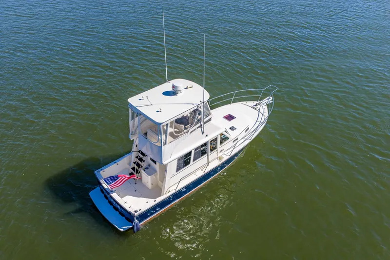Slide: The Image of 2006 Sabreline 36 Fly yacht cruising on calm waters, aerial view. - 55
