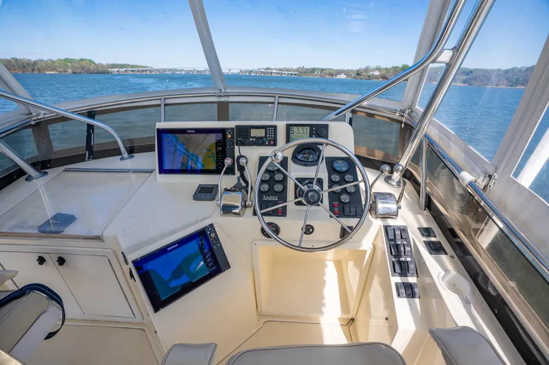Slide: The Image of Helm of 2006 Sabreline 36 Fly yacht with navigation equipment and scenic water view. - 57