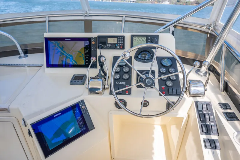 Slide: The Image of 2006 Sabreline 36 Flybridge helm with navigation screens and controls. - 58