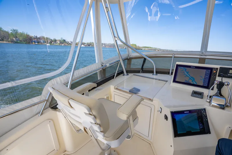 Slide: The Image of Helm of 2006 Sabreline 36 Fly yacht with navigation equipment and scenic water view. - 59