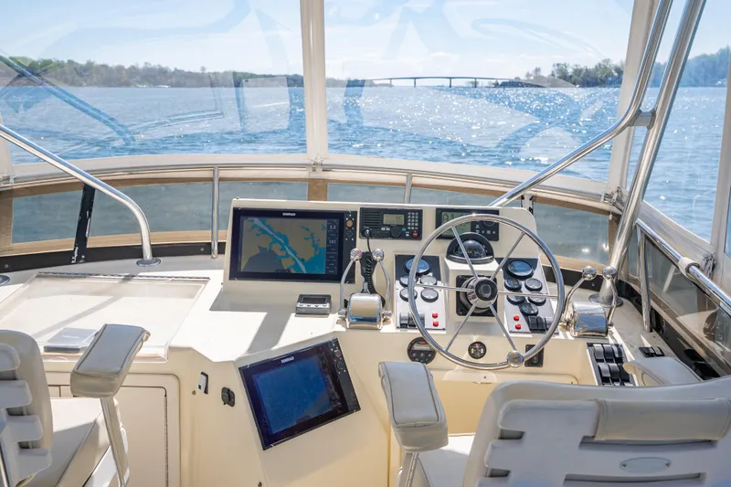 Slide: The Image of 2006 Sabreline 36 Flybridge yacht helm with navigation equipment and scenic water view. - 62