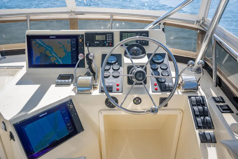 Slide: The Image of Cockpit of 2006 Sabreline 36 Fly with navigation screens and steering wheel. - 67
