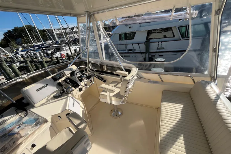 Slide: The Image of 2006 Sabre 36 Flybridge Sedan helm with Simrad navigation, docked at marina. - 7