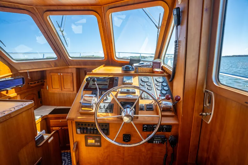 Slide: The Image of Helm of 2006 Sabreline 36 Fly yacht with wooden interior and ocean view. - 77