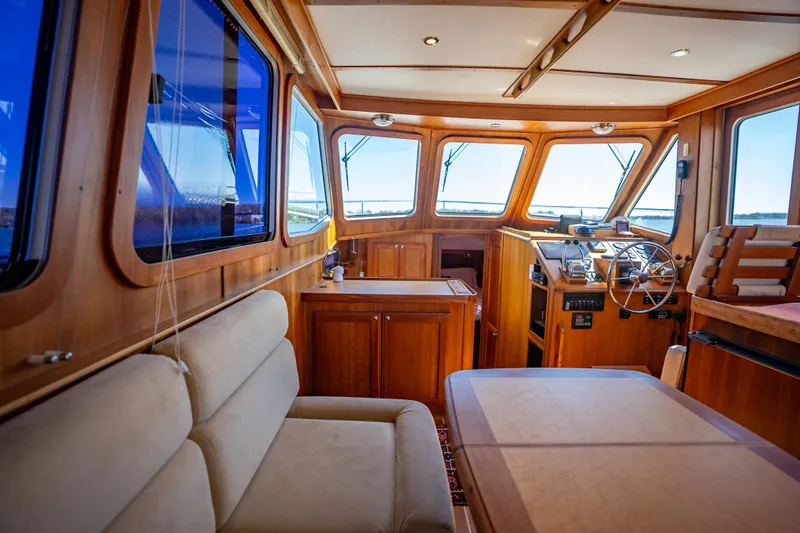 Slide: The Image of Interior of 2006 Sabreline 36 Fly yacht with wooden finish and steering area. - 82