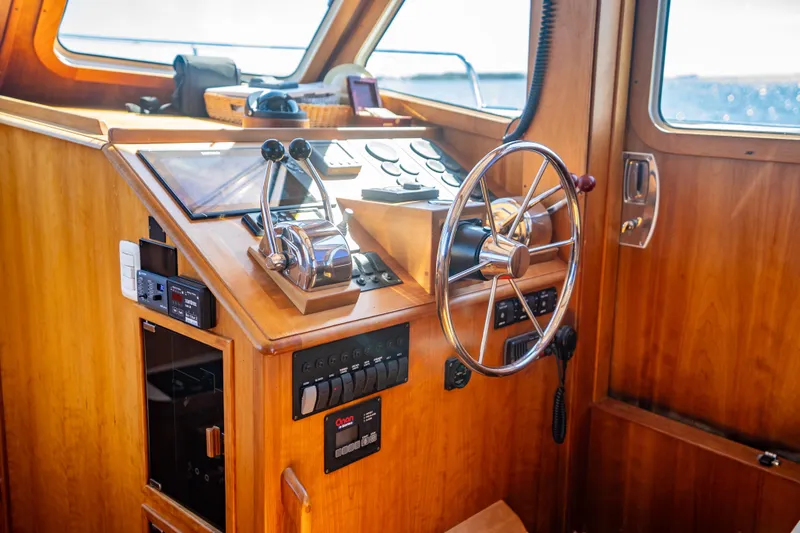 Slide: The Image of Helm of 2006 Sabreline 36 Fly yacht with wooden finish and modern controls. - 84