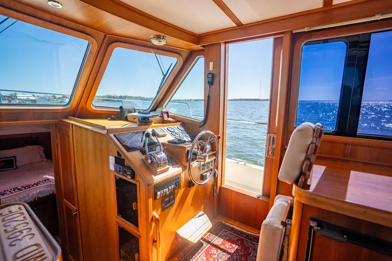 Slide: The Image of Interior of 2006 Sabreline 36 Fly yacht with wooden helm and ocean view. - 85