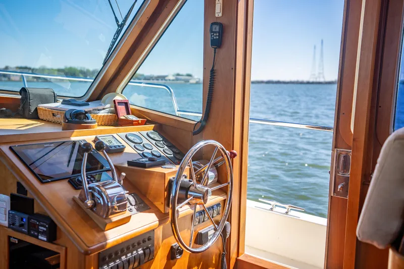 Slide: The Image of Interior view of 2006 Sabreline 36 Fly yacht helm with ocean backdrop. - 86